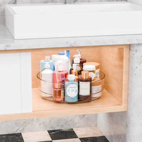Clear 12 Inch Lazy Susan Turntable Set With Handles 4 Pack Acrylic Organizer in bathroom cabinet with cosmetics.