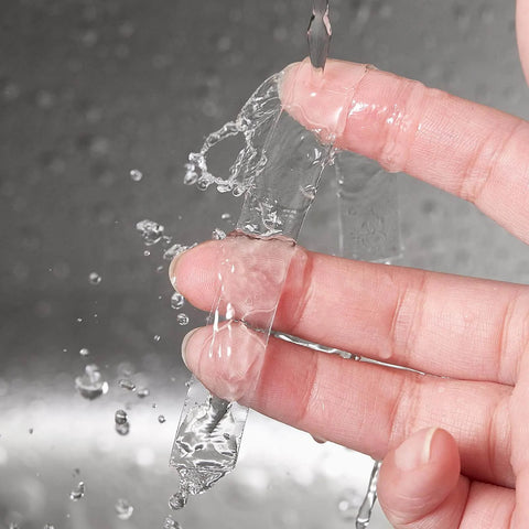 Heavy Duty Double Sided Tape Half Inch By 10 Feet Clear Acrylic Mounting Tape shown as washable and reusable on fingers under water