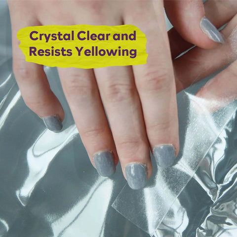 Close-up of hand peeling Extra Sticky Clear Double Sided Tape Removable Heavy Duty Mounting Tape 2 Inch By 20 Yards