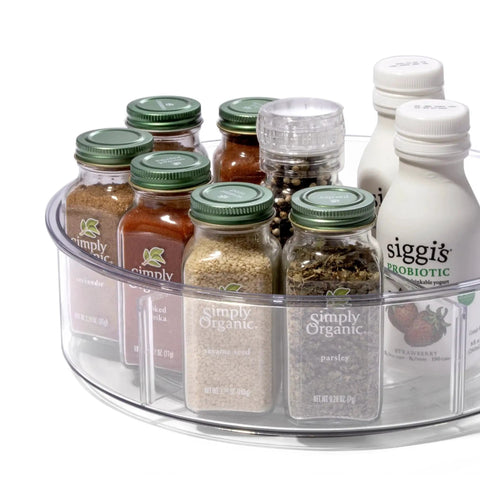 Round Turntable Organizer With Six Removable Clear Bins holding spices and bottles on a kitchen counter