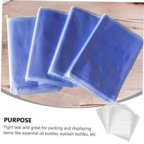 Blue shrink bags displayed on wooden table, showcasing tight seal quality for packing items like essential oil and eyelash bottles.