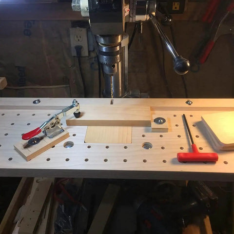 Heavy Duty 5 Pack Hold Down Toggle Clamps With Quick Release on a pegboard workbench, 200 lb capacity, antislip red vinyl handles.