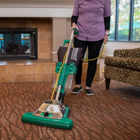 Commercial Upright Vacuum With ProCup Comfort Grip, 870W Motor, 16-Inch Cleaning Path in use on carpeted floor