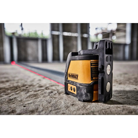 Compact Self Leveling Red Cross Line Laser on construction site, showing red beam projected on the floor, highlighting 165 ft range.