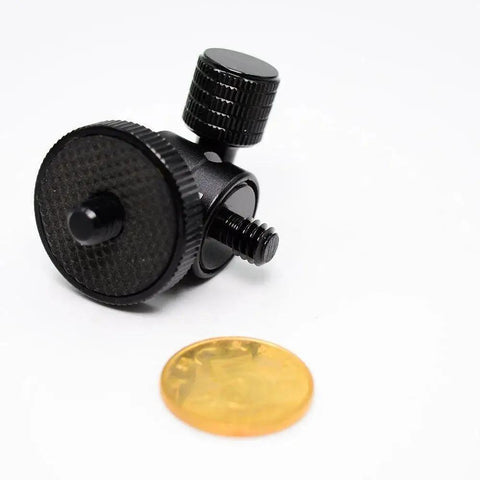 Compact Mini Ball Head Tripod Mount With One Quarter Inch Screw Connector for Cameras and DSLRs, shown beside a coin for size reference.