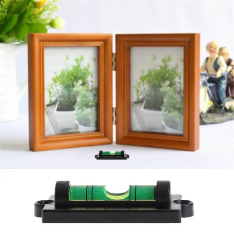 Green bubble spirit level beside two picture frames for 4 Pack RV Levelers With Screws Bubble Spirit Level For Travel Trailer Motorhome Camping Compact 60mm Long Levelers 25mm Wide Heavy Duty Leveling Tools For Quick On The Go Leveling