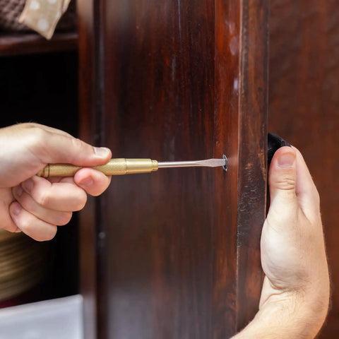 Person using a screwdriver from the 5 In 1 Hammer With Built In Screwdrivers Chrome Plated To Resist Rust Lightweight Compact Multitool