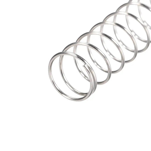 Close-up of a 304 Stainless Steel compression spring for DIY projects, 15mm outer diameter, 1mm wire size, silver tone, 60mm free length