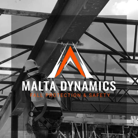 Construction worker using Malta Dynamics fall protection gear on steel framework.