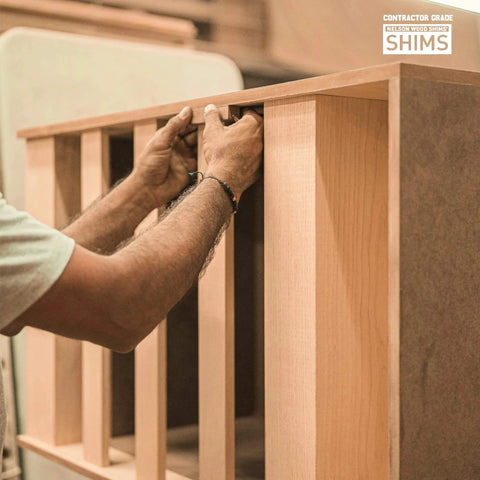 Person using Contractor Grade Wood Shims 56 Count 8 Inch Pack for Leveling and Precise Alignment Easy Snap Design in carpentry