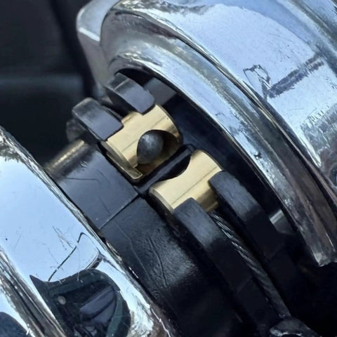 Copper throttle idle cable ferrule for Harley Davidson carburetor throttle cable end joint, installed on motorcycle.
