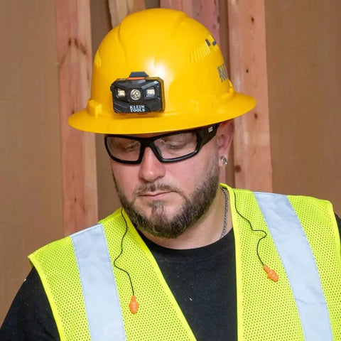 Worker wearing Corded Reusable Earplugs With 25dB NRR In Bright Orange Case Included For Construction And Loud Environments