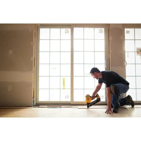 Cordless 15 Gauge Angled Finish Nailer 20V Max XR Renewed For Trim Molding Baseboards Crown Casing And Cabinetry Installation With Brushless Motor Long Lasting Battery And Dual Range Depth Control For Precise Fewer Nicks And Quick Clean Finish Work being used by a person installing molding near a window