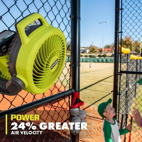 Cordless 18V Hybrid Whisper Series 7.5 Inch Fan Tool Only Bare Tool For Lawn Care Pros installed on fence at baseball field.