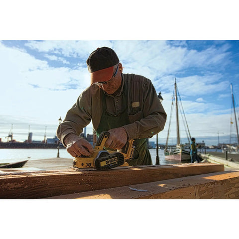 Person using Cordless 20V Max Planer Bare Tool Only With 30,000 CPM And 2 Mm Cut Depth Brushless Motor at a waterfront job site.