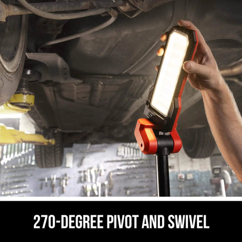 Cordless Compact Tower Light Kit with 20V Power in use, illuminating under a car with PWR CORE 12V or 20V batteries setup, adjustable position.