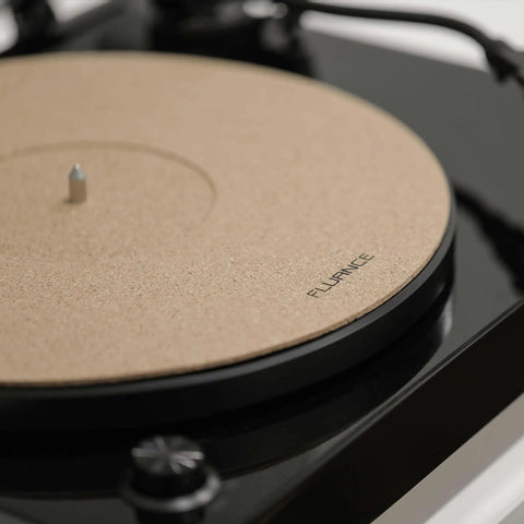 Improve vinyl sound and reduce surface wobble with a cork platter mat shown on turntable, enhancing contact and vibrations.