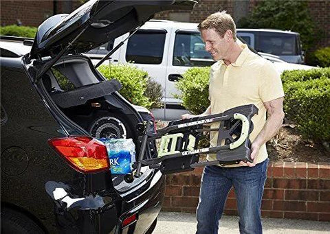 Person loading COSCO Shifter Multi-Position Folding Hand Truck and Cart, 300 lb. Weight Capacity, Green, 12222PBG1E into car trunk.