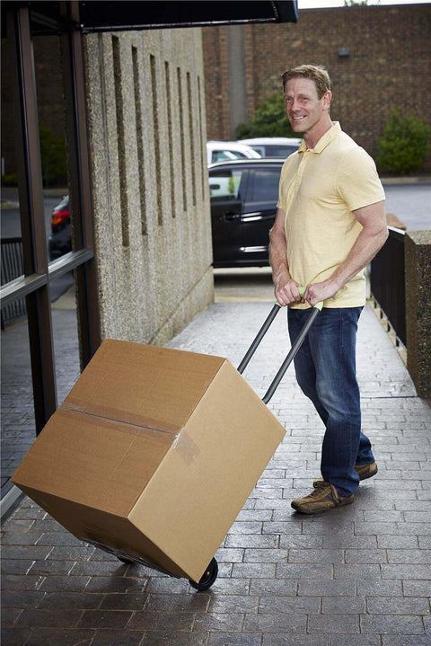 Person using COSCO Shifter Multi-Position Folding Hand Truck and Cart, 300 lb. Weight Capacity, Green, 12222PBG1E to move a box