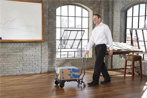 Person using the ✝️ COSCO Shifter Multi-Position Folding Hand Truck and Cart, 300 lb. Weight Capacity, Green, 12222PBG1E indoors