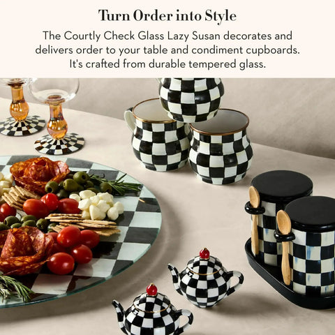 Mackenzie-Childs Glass Lazy Susan 360 Degree Rotating Serving Board In Black And White Courtly Check with condiments and dishes