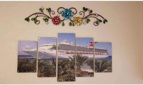 Decorative metal wall art above a segmented cruise ship photo mounted with stainless steel standoffs screws.
