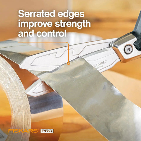 PowerArc Heavy Duty Shop Shears cutting tape, showcasing curved serrated blades and extended tang for construction use.