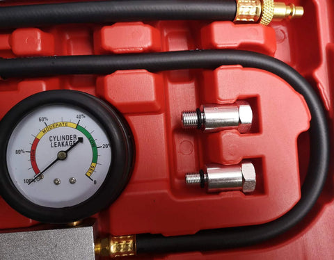 Cylinder leak-down tester kit with round gauge, red case, black hose, and metal adapters