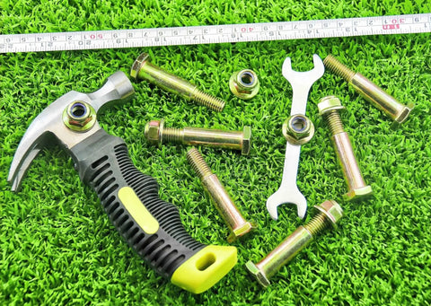 Two Pack Deck Wheel Shoulder Bolts And Flanged Locknut Kit For Half Inch Bore Wheels with tools on grass background