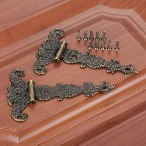 Two Piece Black T Strap Decorative Furniture Hinges Zinc Alloy Butt Hinges for cabinets on wooden surface; size 113 by 69 mm.