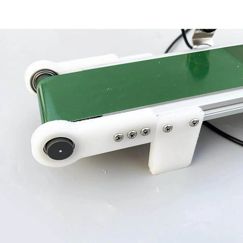 Close-up of green PVC desktop conveyor belt, 1000mm x 10cm, for smooth transport and physics friction experiments, with automatic counter.