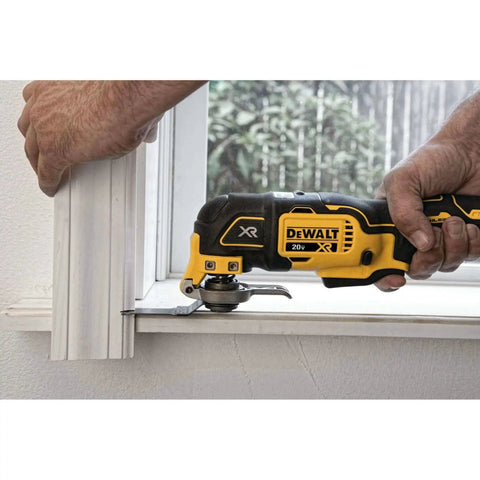 Hands using DEWALT 20V MAX XR Cordless Oscillating Multi Tool With Variable Speed Brushless Motor LED Work Light for cutting