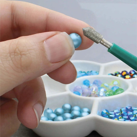 Diamond Tipped Bead Reamer Set For Jewelry Making With Color Coded Plastic Handles A Four Piece Steel Diamond Drill Kit To Enlarge Holes And Smooth Edges The Beadsmith close-up view of tool in use on a bead, showing detail of drill tip.