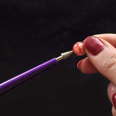 Diamond Tipped Pro Grade Bead Reamer Set For Jewelry Making And Beading Tools 10 Piece Kit in use on bead with plastic handle visible