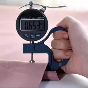 Digital thickness gauge measuring linen fabric, related to 3 Pack Door Silencers And Stoppers With Adjustable Elastic Straps, Soft Cotton Cushioned Pads