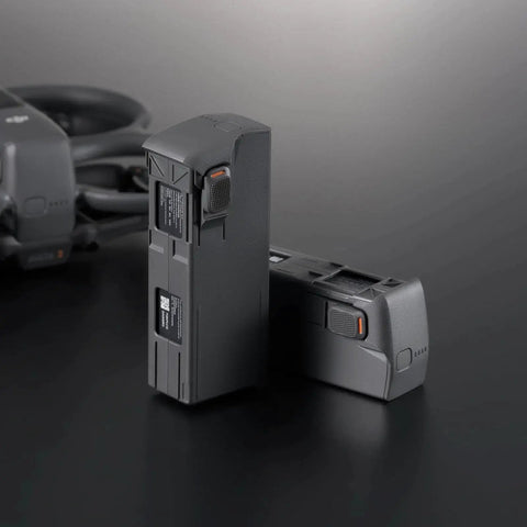 Two DJI Avata 2 Intelligent Flight Batteries deliver about 23 minute flight time for DJI Avata 2 FPV drone on a dark surface.