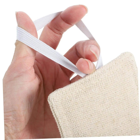 Close-up of hand holding beige fabric with elastic strap, part of three-piece, no-tool door silencers preventing finger pinches and noise.