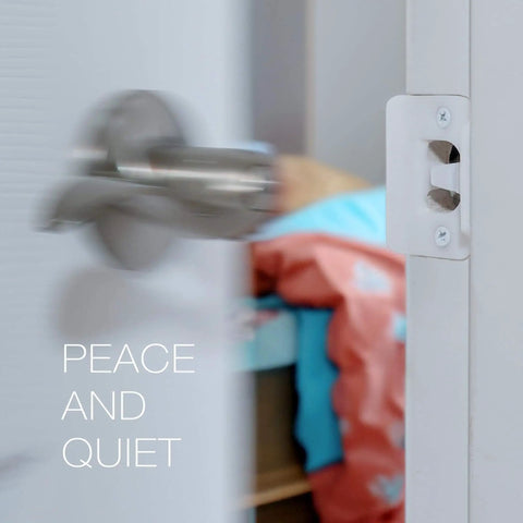 Door Silencer Strike Plate With Adhesive Bump Stops For Loud Doors No Drills Required Easy No Tools Install Flexible Noise Eliminating Solution That Stops Slamming Noises White Finish installed on door jamb next to a blurred open door.