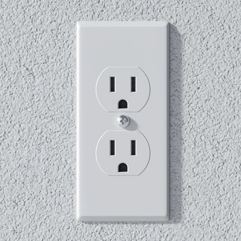 Electrical outlet mounted on textured wall, suitable for various household appliances and electronics.