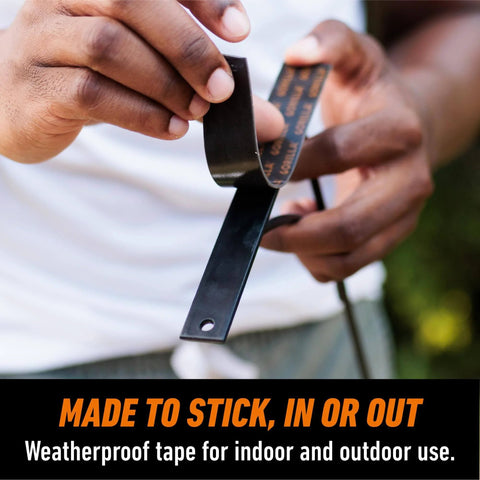 Person holding Heavy Duty Double Sided Mounting Tape Black 1 Inch By 120 Inch Weatherproof For Indoor Or Outdoor Use.