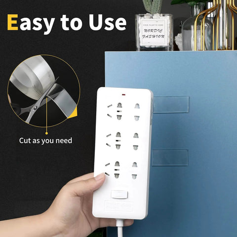 Person using Heavy Duty Double Sided Tape Roll Set to mount power strip on cabinet, includes clear wall mounting tape and removable poster tape
