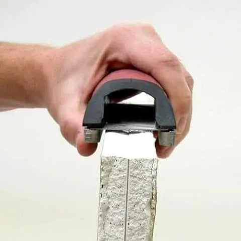 Efficient 5.5 inch drywall rasp with guard rails shaping plaster edge, DuraSoft grip for dual-direction use, precise finish.