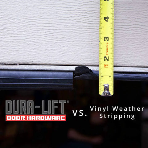 DURA-LIFT garage door double-T rubber weather seal on bottom of beige door with yellow measuring tape for scale