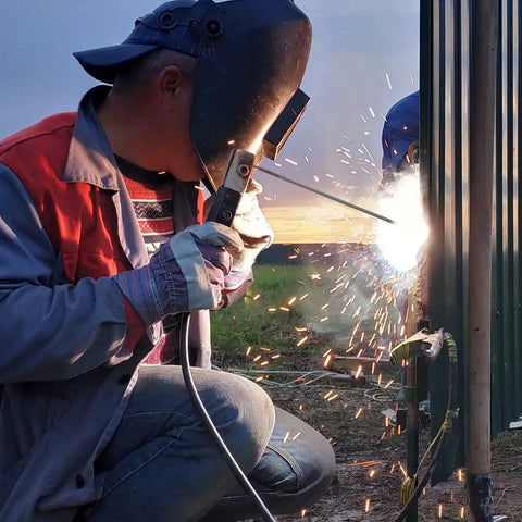 Welder using E7018 Low Hydrogen Iron Powder Welding Rods 1/8 Inch Diameter 14 Inch Long for carbon steel arc welding on metal