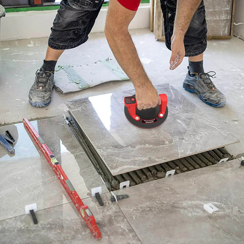 Worker using 8 Inch Electric Glass Vacuum Suction Cup Lifter Beefy 600 Lbs Max Load on tile installation