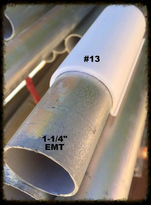 Pro Series Snap Clamps 1 Inch 20 Pack Gray Snap Clamps With Rounded Edges For Safer Fabric And Plastic Ideal For Attaching Tarps Or Netting To Pipe Or EMT Highly Compatible With Many Pipe Types shown installed on EMT pipe with metal texture.