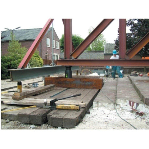 Enerpac P-392 2 Speed Lightweight Hand Pump in use for lifting a steel beam on a construction site with hydraulic setup