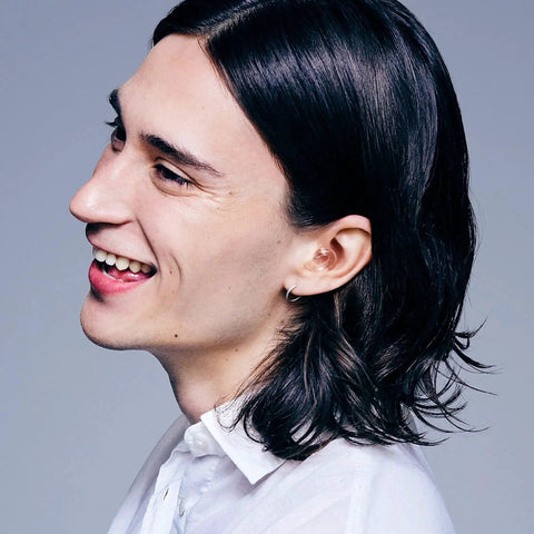 Person smiling wearing Engage 2 Ear Plugs For Everyday Use With 16 dB Noise Reduction And Clear Speech, side view