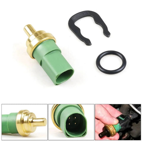 SCHUSSPART TS477 coolant temperature sensor with green plastic body, brass tip, O-ring and mounting clip.