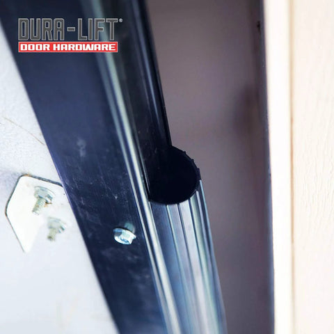 DURA-LIFT garage door rubber weather seal; black rubber strip along metal door frame with screws visible.